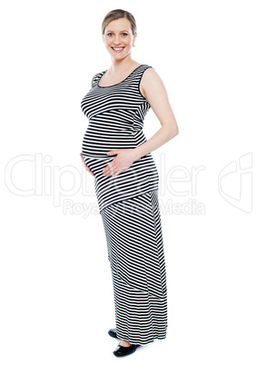 Cheerful pregnant lady in fashionable attire