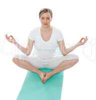 Young woman meditating in lotus pose