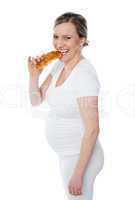 Pretty pregnant lady eating fast food