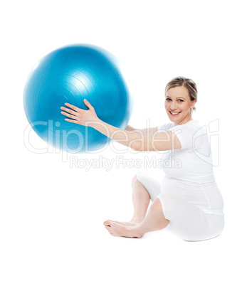 Pregnant woman playing with exercise ball