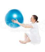 Pregnant woman sitting with exercise ball