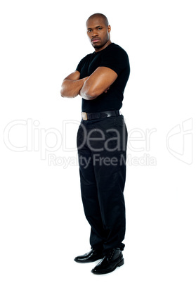 Male security guard with strong arms crossed