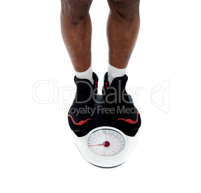 Man's feet on weighing scale