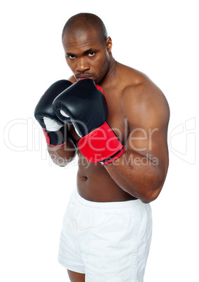 Shirtless african boxer aiming to punch you