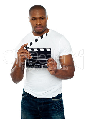 Masculine african male holding clapperboard