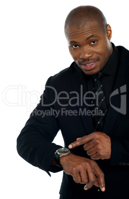 African male indicating towards wrist watch
