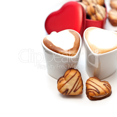 heart shaped cream cookies on red heart metal box and coffee