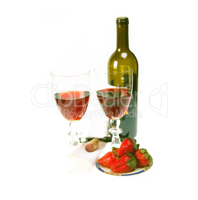 red wine bottle and two glasses with strawberries