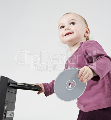 young child playing with CD