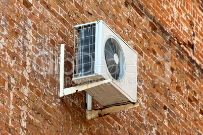 Air conditioner on old brick wall