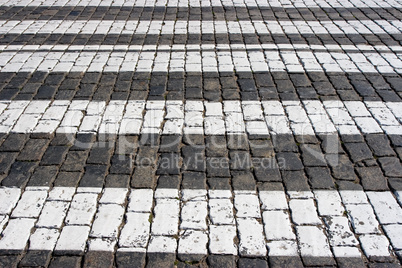 Cobblestone road background with white lines
