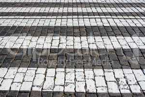 Cobblestone road background with white lines