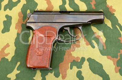 Russian 9mm handgun on camouflage background