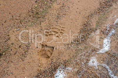 Boot imprint on the beach sand