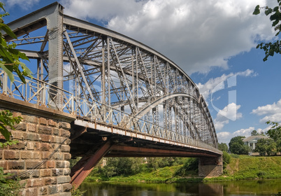 Steel Arch Bridge on river Msta. Novgorod region, Russia.