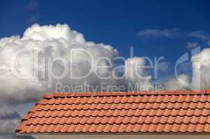 Roof tiles and blue sky with clouds