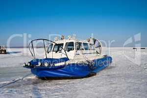 Hovercraft on the bank of  frozen river