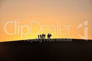 Silhouette of travelers at sunset