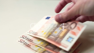 Hands Spreading Euro Bills