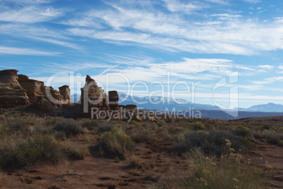 Soft light on desert and rocks with Henry Mountains, Utah