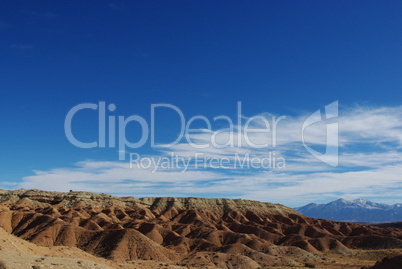 Interesting red and white sandstone hills with Henry Mountains, Utah