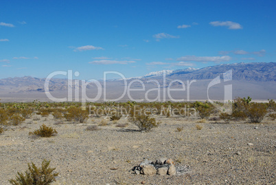 Fire pit, vast desert and high snowy mountain range near Mount Charleston, Nevada