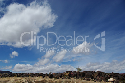 Black rocks under beautiful cloudy skies near Death Valley, California