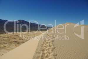Mojave dune, blue sky and mountains, California