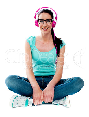 Teenager sitting on floor and listening music