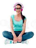 Teenager sitting on floor and listening music