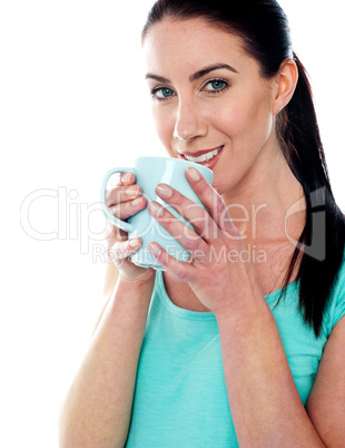 Smiling girl drinking coffee
