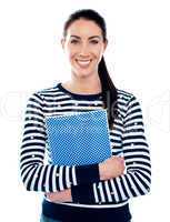 Attractive girl holding blue spiral notepad