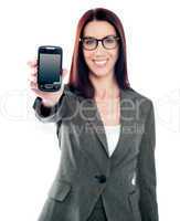 Saleswoman displaying latest mobile handset