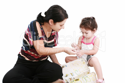 Beautiful little girl playing with her mother on the floor