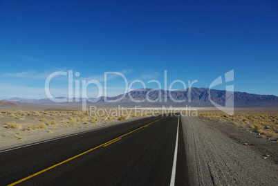 Highway to salt flats and high mountain range, Nevada