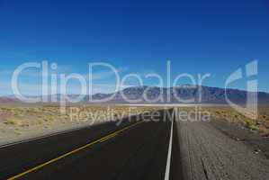 Highway to salt flats and high mountain range, Nevada