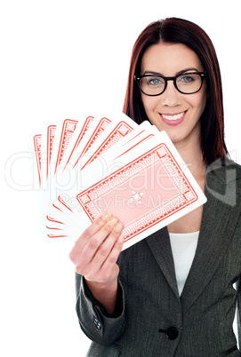 A beautiful woman holding playing cards
