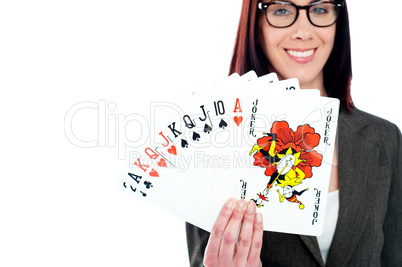 Charming businesswoman holding playing cards