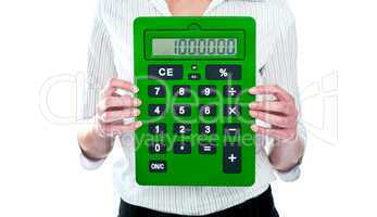 Focus on green calculator. Woman holding