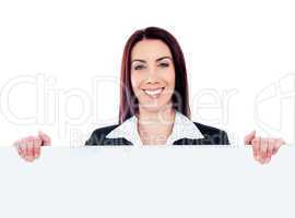 Young beautiful woman standing behind billboard