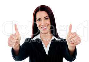 Confident businesswoman showing double thumbs-up