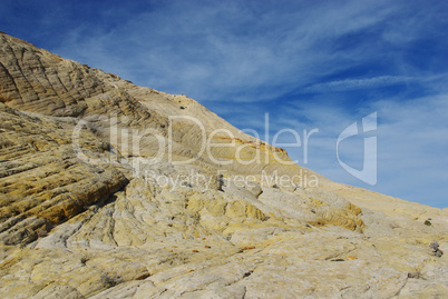 White and yellow rocks under blue and white skies, Utah