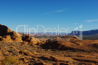 Orange rock hills, Lake Powell in the distance and wide view on high desert of Southern Utah and Northern Arizona