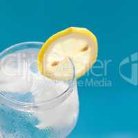 a wine glass with ice and  lemon
