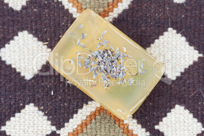 lavender and soap on ethnic mat