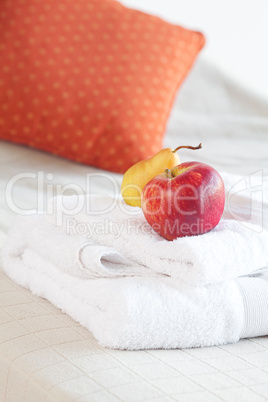 cup of tea,apple and pear on the bed