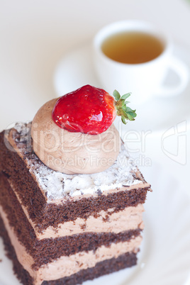 beautiful cake with strawberry and tea on a white background