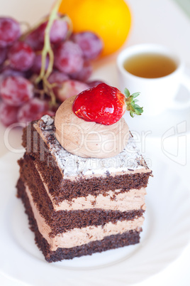 beautiful cake with strawberry,grape,mandarin and tea