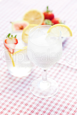cocktail with ice,lemon, fig and strawberries on a plate