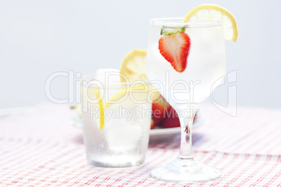 cocktail with ice,lemon, fig and strawberries on a plate